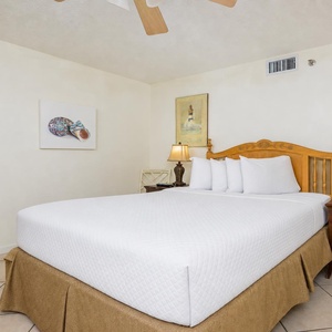 Relax in the guest bedroom featuring a queen bed, soft linens, and coastal decor for a refreshing getaway