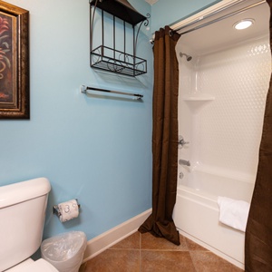Experience a refreshing shower in this guest bath, surrounded by calming decor, perfect for unwinding after beach fun