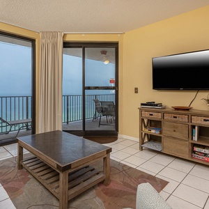 Relax in the inviting living area with a comfortable sofa with queen sleeper, coffee table, and a large TV