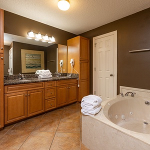 Refresh in the master bath after a day at the beach with a soothing jetted tub and relaxing walk-in shower