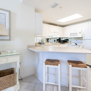 Prepare meals and enjoy morning coffee at the kitchen bar, featuring stylish stools and coffee maker with Keurig addition