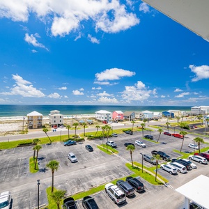 This bright and airy space offers a stunning beach view with vibrant blue skies and colorful beach houses lining the shore