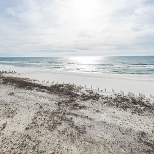 Gaze at the serene waters and soft shoreline, perfect for beach walks and relaxation under the sun