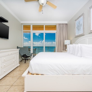 Unwind in the serene master bedroom with a king bed, stylish decor, and breathtaking beach views
