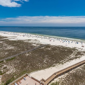 Gaze at the vast coast below, feeling the sun's warmth and the soothing sounds of waves lapping at the shore