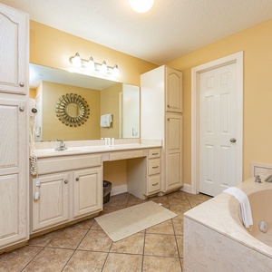 The master bath invites you to refresh with a soothing soak in the corner jetted tub after a day on the coast