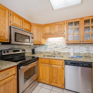 Warm wood cabinets surround your kitchen where you prepare fresh meals and share vacation moments