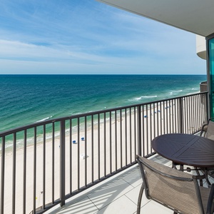 Breathe in the fresh air while enjoying meals at the balcony table with expansive views of the tranquil shoreline