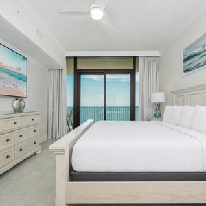 Relax in the inviting master bedroom after a day at the beach with your favorite shows and stunning views