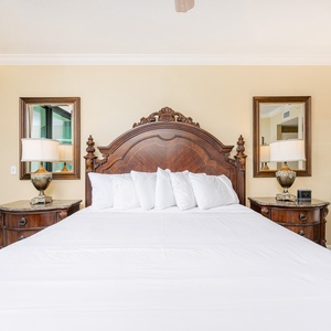 Rest in the king bed in the master, surrounded by soft pillows, and drift into restful sleep as you feel the balcony breeze