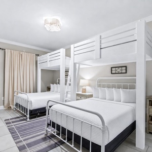 Spacious guest room featuring two loft twin beds over two queen beds, for restful nights