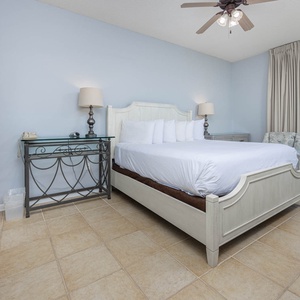 Relaxing master suite bedroom featuring a king bed and beachfront patio access