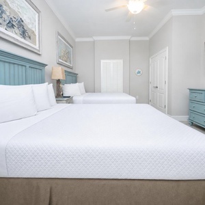 Sink into the soft, plush queen bedding after a day of beach adventures, enjoying a restful sleep in this guest room