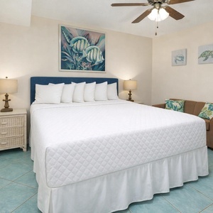 Rest on the plush king bed or curl up on the cozy sofa, savoring the inviting beach decor in this suite