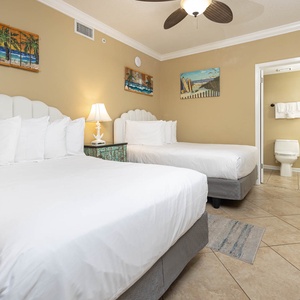 Rest in comfort with two plush double beds, charming decor, and a warm vibe in this guest bedroom
