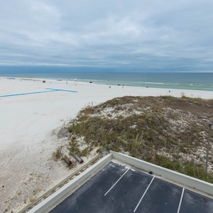 Breathtaking view of the soft pristine beach and tranquil waters, perfect for a relaxing getaway