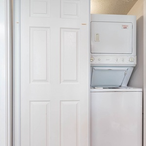 This laundry area features a stacked washer and dryer, perfect for your convenience during your stay