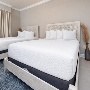 Relax on one of the cozy queen beds in this guest suite and enjoy a peaceful slumber