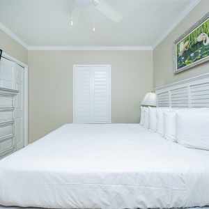 Relax in this comfortable guest room featuring a king bed, light decor, and a TV for your entertainment