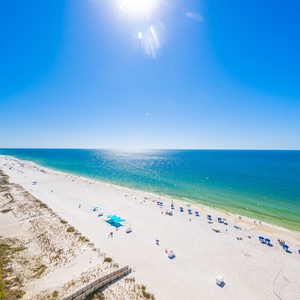 Endless blue skies cool your skin as you stroll along the gleaming white beach below your balcony