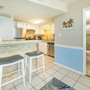 Enjoy casual conversations while seated at the bar, surrounded by bright coastal decor and a welcoming vibe