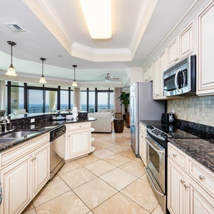 Prepare meals in this kitchen with elegant cabinetry, stainless appliances, and spacious countertops