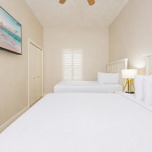 In this guest suite with two queen beds, settle into plush bedding while the TV plays calming beach scenes