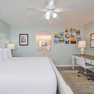 Your king master suite offers a restful retreat with plush bedding and calming coastal art nearby