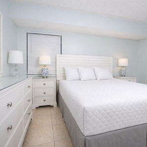 This inviting bedroom features a comfortable bed, stylish lamps, and a serene color palette for a restful stay