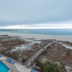 Gaze at the serene waters and gentle waves from your balcony, with a poolside view for relaxation