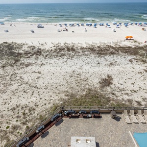 Relax by the poolside with comfortable seating and enjoy easy access to the beach just steps away