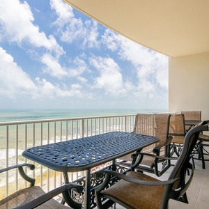 Relax on the balcony with comfortable seating and enjoy expansive views of the coastline