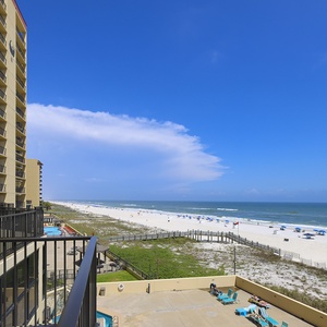 Enjoy breathtaking views of the serene beach and vibrant blue waters from your private balcony