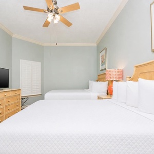 Drift into restful nights on the soft queen beds, enjoying cozy evenings with your family in this guest bedroom