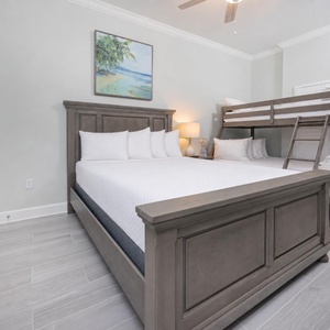 Charming bunk room with a plush queen bed and a twin over full bunk