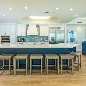 Indulge in family time around the spacious kitchen island, sharing laughter and stories while savoring the coastal vibe