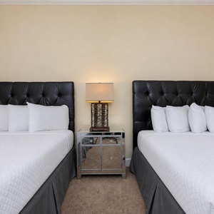 Rest peacefully in this guest room, featuring plush queen beds, perfect for a restful night after beach adventures