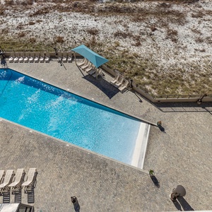 Relax by the sparkling gradual entry pool, surrounded by comfortable loungers and shaded areas for a refreshing escape