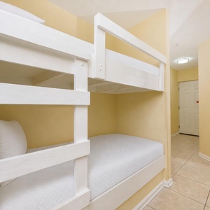 Two bunk beds in the sleeping area invite kids to dream after a day of beachside fun and family adventures