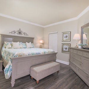 Retreat to this serene master bedroom featuring a king bed, elegant decor, and ample storage for your belongings
