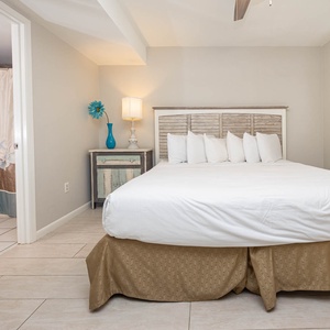 The master bedroom features a comfortable king bed, stylish decor, and an adjoining bathroom