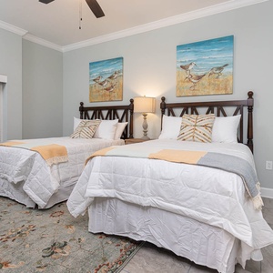 Sink into plush double beds and read under the lamp and shore bird art in this charming guest suite