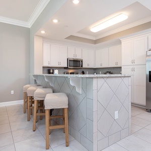Wake up with morning coffee at the breakfast bar and get ready for a beach day in this stylish space