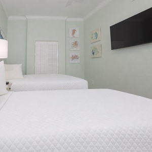 Unwind in this queen guest suite and admire the marine prints as you relax with your favorite show