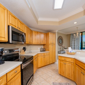 Prepare meals in this kitchen with elegant cabinetry, stainless appliances, and spacious countertops