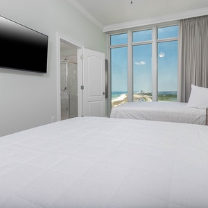 Stretch out on the queen beds and watch the gulf through tall windows from this guest suite