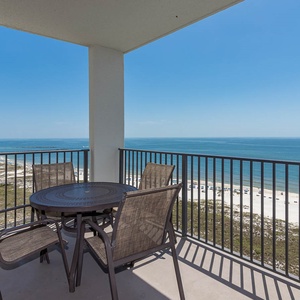 Balcony seating offers a serene view of the tranquil gulf and nearby beach, perfect for relaxing in the sun