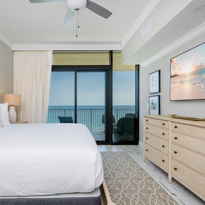 Unwind in the master suite with a cozy king bed, stylish decor, and beachfront balcony access