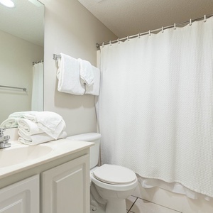 Refresh in this guest bathroom featuring a spacious vanity, neatly arranged towels, and a calming vibe for your comfort