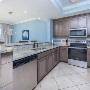 Prepare meals in this kitchen with elegant cabinetry, stainless appliances, and stylish backsplash